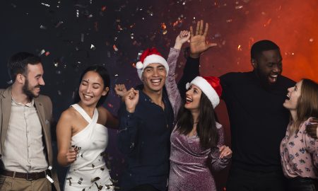 Friends having fun at a holiday party. Photo by Freepik.