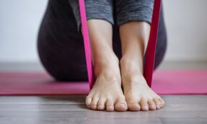 Young woman doing sports exercises with elastic band. Image by pvproductions on Freepik.