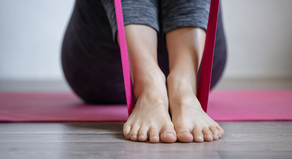 Young woman doing sports exercises with elastic band. Image by pvproductions on Freepik.