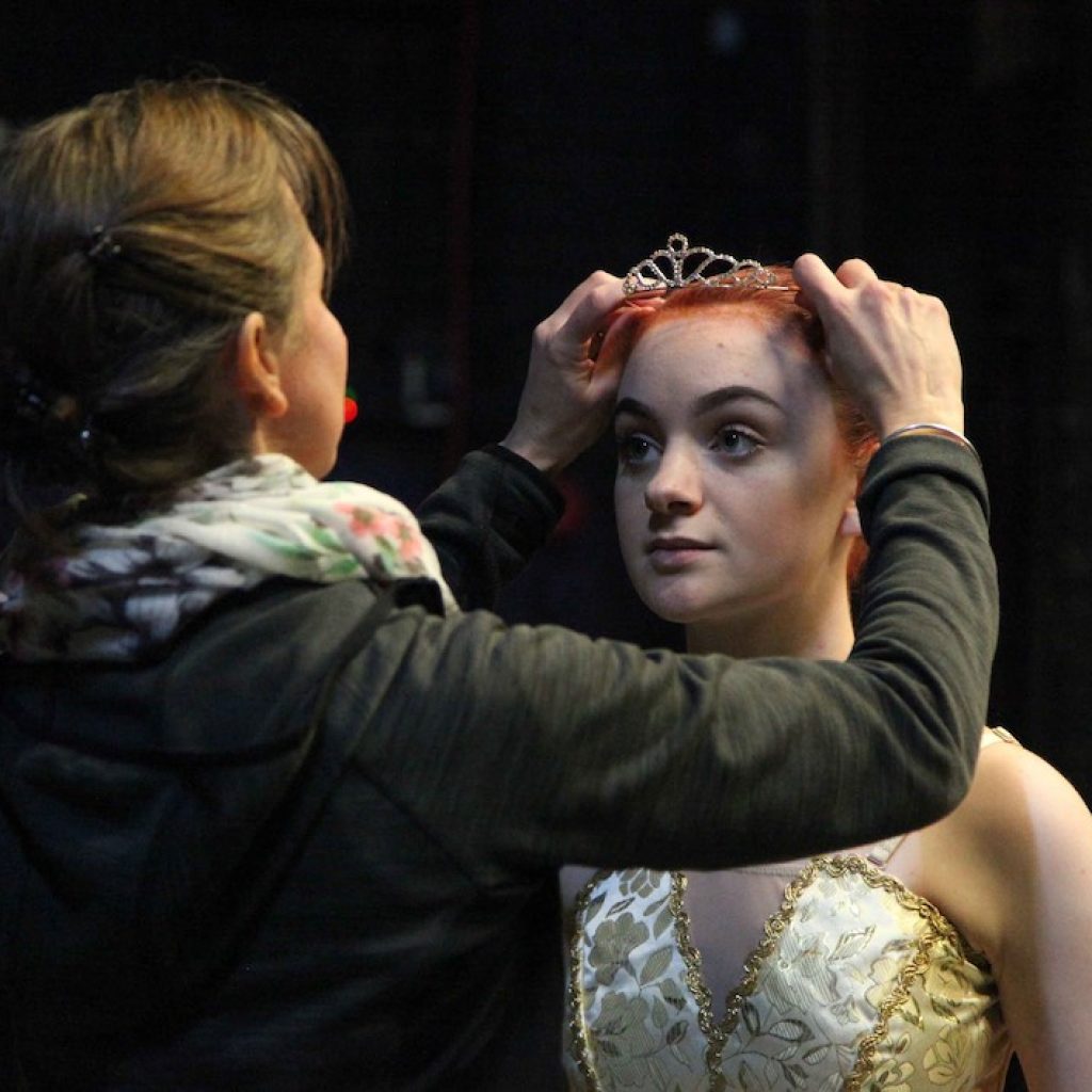 Mari-Louise Britz adjusting student Ailish Williams’s tiara in rehearsal. Photo courtesy of Britz.